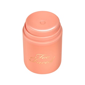 Too Faced Primed & Peachy Primer in peach-pink cylindrical pot with gold script branding and push-up base