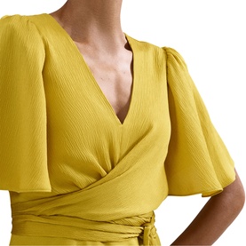 Model wearing Phase Eight yellow wrap dress with flutter sleeves, V-neckline, and textured fabric, shown in close-up detail