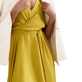 Model wearing Phase Eight yellow wrap dress with tie waist detail, styled with a cream blazer