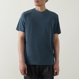 Model wearing Belstaff Alloy Logo T-Shirt in petrol, crew neck, short sleeves, straight hem, styled with dark trousers.