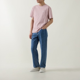 Model wearing Belstaff Border Logo Back Graphic T-Shirt in Dusk Pink with blue straight-leg jeans and white trainers.