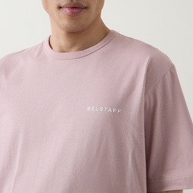 Model wearing Belstaff Border Logo Back Graphic T-Shirt in Dusk Pink, with white chest logo, crew neck, short sleeves, 100% cotton