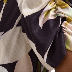 Phase Eight black multi floral print dress, close-up detail showing large abstract floral pattern with olive and cream tones on textured fabric
