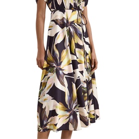 Model wearing Phase Eight black multi floral midi dress with yellow and cream lily print, elasticated waist and flared skirt