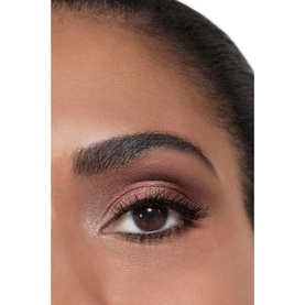 Close-up of eye makeup look featuring shimmery rose pink and warm brown eyeshadow with defined liner