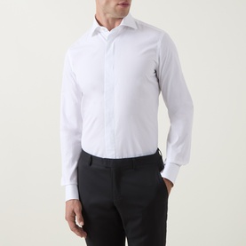 Model wearing Gherardi white cotton evening shirt with spread collar, styled with black trousers
