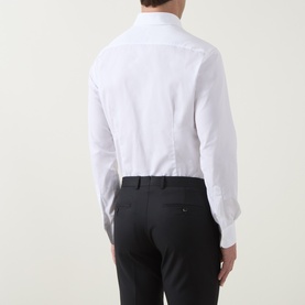 Model wearing Gherardi white cotton evening shirt, back view, paired with black tailored trousers.