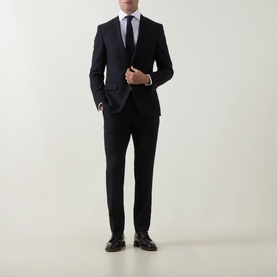 Model wearing Gherardi White Single Cuff Regular shirt, styled with dark navy suit, tie, and black leather dress shoes.