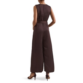 Model wearing Phase Eight brown polka dot sleeveless wide-leg jumpsuit with V-neckline and belted waist, styled with black heels.