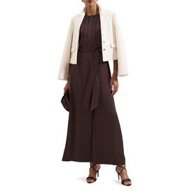 Model wearing Phase Eight brown polka dot wide-leg jumpsuit, styled with cream blazer and black heeled sandals
