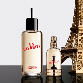 Jean Paul Gaultier La Favorite Eau de Parfum refill bottle and EDP bottle displayed beside a miniature Eiffel Tower