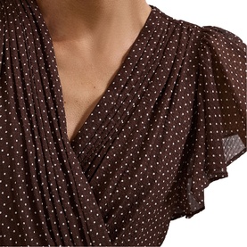 Model wearing Phase Eight brown polka dot wrap dress with flutter sleeves and V-neckline, chiffon fabric