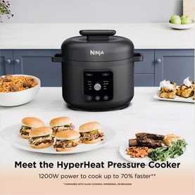 Ninja Hyper Heat 9 in 1 Pressure and Rice Cooker in black, shown in kitchen setting with cooked meals including burgers and rice dishes.