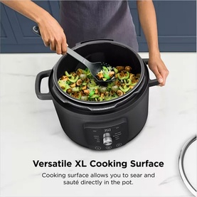 Ninja Hyper Heat 9 in 1 Pressure and Rice Cooker in black, open lid showing vegetables being stirred inside the XL cooking pot.