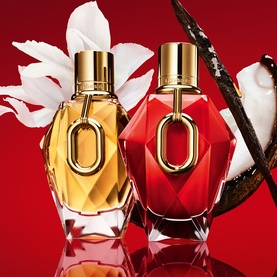 Paco Rabanne Million Red For Her Parfum in red faceted bottle with gold cap, styled alongside a second fragrance on red background