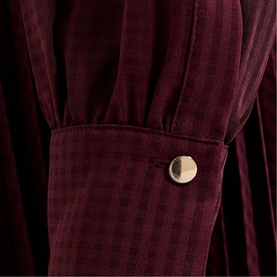 Phase Eight red velvet striped dress detail showing gathered cuff with gold button fastening
