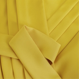 Phase Eight yellow dress fabric detail showing pleated and draped grosgrain trim against smooth crepe-like textile