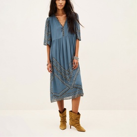 Model wearing Bash blue midi dress with V-neck, half sleeves and embroidered trim detail, styled with tan ankle boots