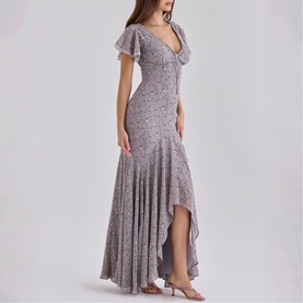 Model wearing House of CB Lilac Vintage Floral maxi dress with flutter sleeves, deep V-neck, and asymmetric hem