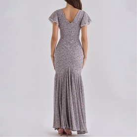 Model wearing House of CB Lilac Vintage Floral maxi dress, back view, flutter sleeves, V-back, fitted bodice with flared hem