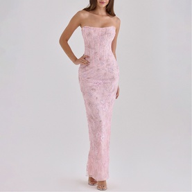 Model wearing House of CB pink strapless maxi dress with floral lace texture and fitted corset bodice