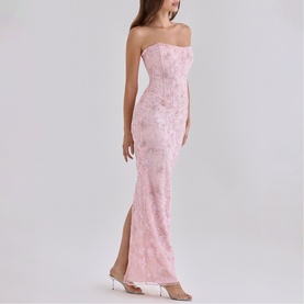 Model wearing House of CB pink strapless maxi dress with floral texture, fitted silhouette and side split, styled with white heels