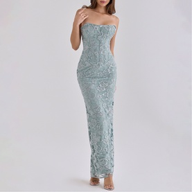 Model wearing House of CB jade strapless maxi dress with floral lace appliqu&eacute; detailing and fitted silhouette