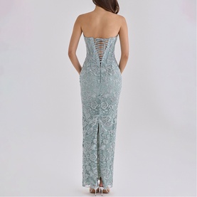 Model wearing House of CB jade lace strapless maxi dress, rear view showing corset lace-up back detail and centre split hem.