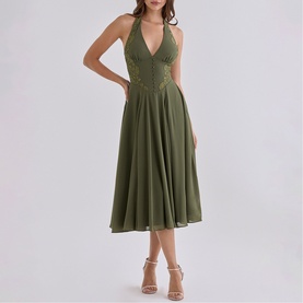 Model wearing House of CB olive halterneck midi dress with lace bodice and A-line skirt, styled with nude heeled sandals