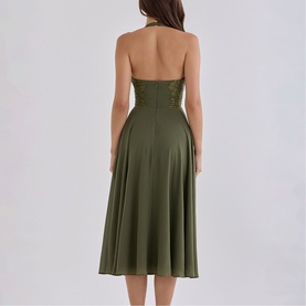 Model wearing House of CB olive halterneck midi dress with corseted bodice and A-line skirt, back view