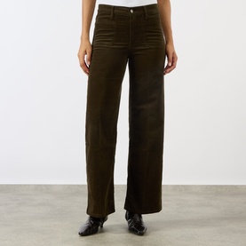 Model wearing FRAME DENIM Le Slim Palazzo Corduroy Wide-Leg Jeans in Rich Military, high-rise wide-leg cut with clean hems, styled with black loafers.