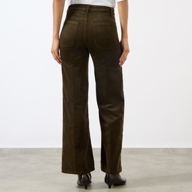Model wearing FRAME DENIM Le Slim Palazzo Corduroy Wide-Leg Jeans in Rich Military, showing rear patch pockets and wide-leg silhouette