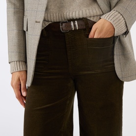 Model wearing FRAME DENIM Le Slim Palazzo Corduroy Wide-Leg Jeans in Rich Military with a brown belt and grey blazer
