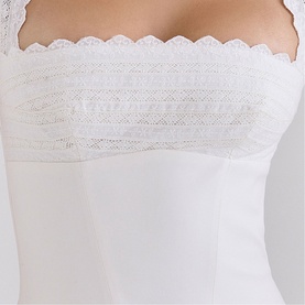 Model wearing House of CB white strapless top with delicate lace trim detail along the bust