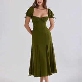Model wearing House of CB olive midi dress with sweetheart neckline, puff sleeves with tie detail, and flared skirt
