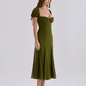 Model wearing House of CB olive midi dress with ruched sweetheart neckline, puff sleeves with tie detail, and flared hem