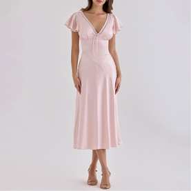 Model wearing House of CB pink midi dress with flutter sleeves, deep V-neckline and A-line skirt, styled with nude heeled sandals