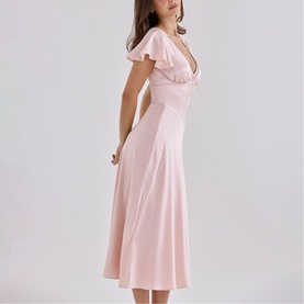 Model wearing House of CB pink midi dress with V-neckline, flutter sleeves and flared skirt, side profile view