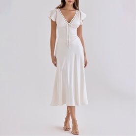 Model wearing House of CB ivory midi dress with flutter sleeves, V-neckline, ruched bodice and flared skirt, styled with strappy heels