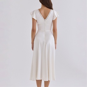 Model wearing House of CB ivory midi dress, back view, flutter cap sleeves, V-back neckline, A-line skirt silhouette