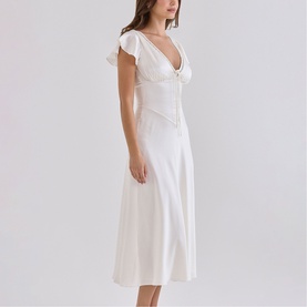 Model wearing House of CB ivory midi dress with deep V-neckline, flutter sleeves, and fitted bodice with A-line skirt.