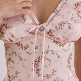 Model wearing House of CB Vintage Rose Floral corset top with lace trim and ribbon tie neckline detail.