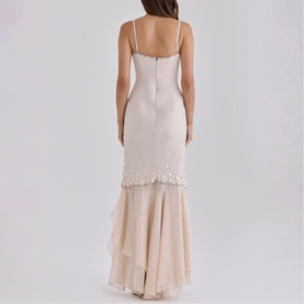 Model wearing House of CB almond maxi dress, rear view, spaghetti straps, pearl-trim hem, layered chiffon frill skirt