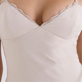 Model wearing House of CB almond corset top with scalloped lace neckline trim, close-up detail shot