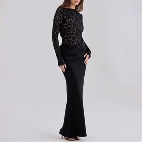 Model wearing House of CB black lace long-sleeve top with black floor-length satin maxi skirt