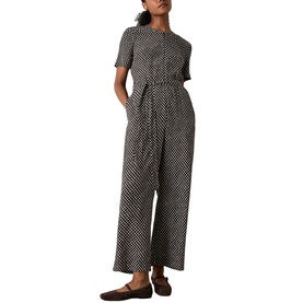 Model wearing Whistles brown geometric print short-sleeve wide-leg jumpsuit with belted waist, styled with dark loafers.
