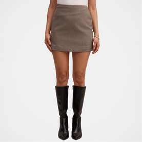 Model wearing Forever New Check Suit mini skirt with front split, styled with black knee-high boots
