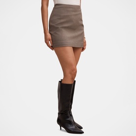 Model wearing Forever New Check Suit mini skirt, styled with black knee-high heeled boots