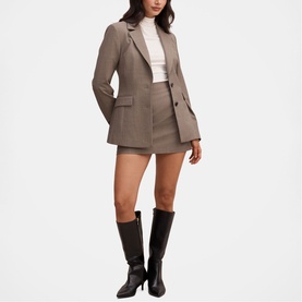 Model wearing Forever New Check Suit blazer and mini skirt, styled with a white top and black knee-high boots.