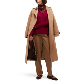 Model wearing Hobbs camel trench coat and burgundy knit, styled with tan trousers, brown flats, carrying a brown leather bag.